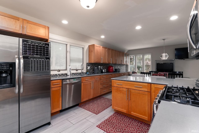 kitchen with recessed lighting, appliances with stainless steel finishes, brown cabinets, tasteful backsplash, and pendant lighting