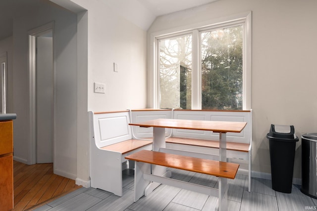 dining space featuring breakfast area, baseboards, and wood finished floors