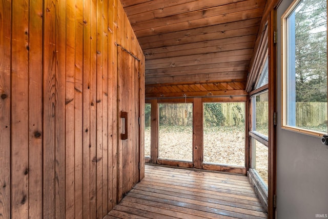 unfurnished sunroom with lofted ceiling and wood ceiling