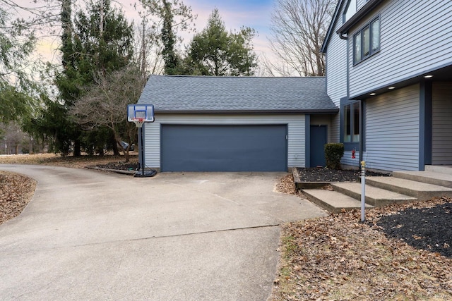 garage featuring concrete driveway