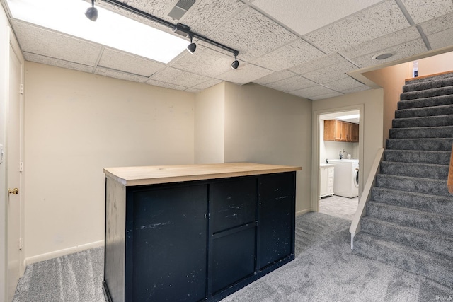 interior space with washer and dryer, carpet, a drop ceiling, and stairway