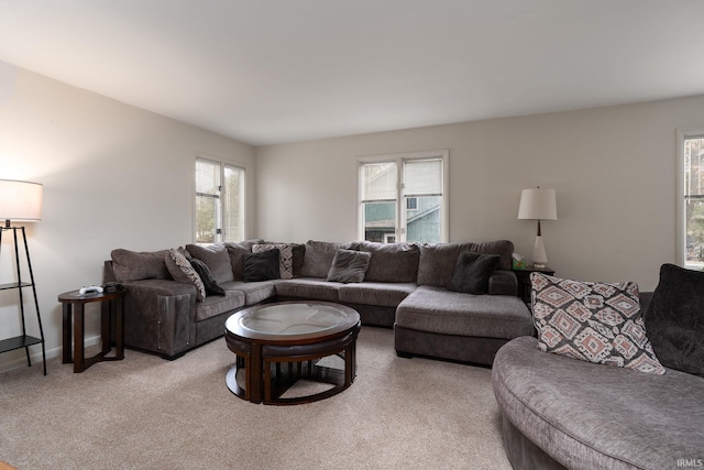 living area with light carpet and baseboards