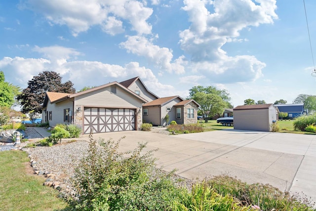 view of front of house featuring an outbuilding, driveway, a shed, and an attached garage