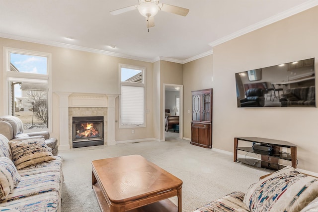 living room featuring ornamental molding, carpet, a tiled fireplace, and baseboards