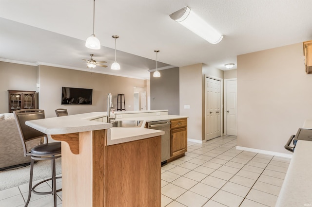 kitchen with appliances with stainless steel finishes, open floor plan, a sink, and light countertops