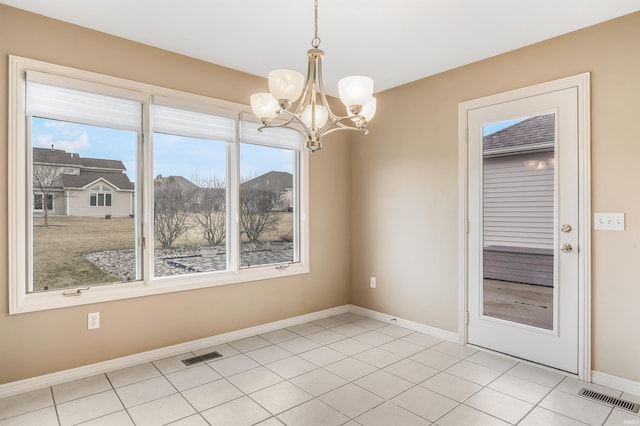 unfurnished dining area featuring a chandelier, light tile patterned flooring, visible vents, and baseboards