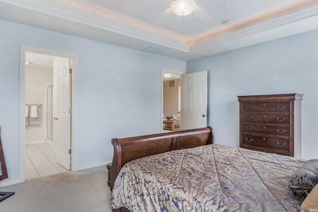 carpeted bedroom featuring baseboards, connected bathroom, ceiling fan, tile patterned floors, and a tray ceiling