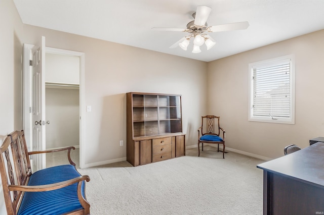 living area featuring carpet, ceiling fan, and baseboards