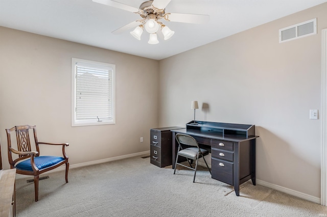 office with light colored carpet, visible vents, ceiling fan, and baseboards