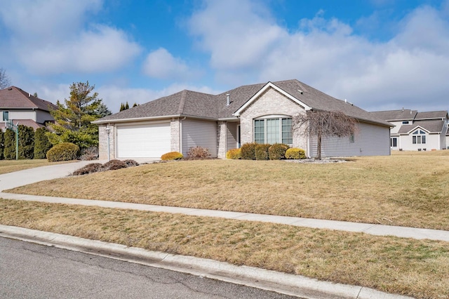 ranch-style house with brick siding, a shingled roof, an attached garage, a front yard, and driveway