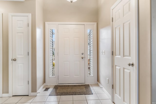 entryway with light tile patterned flooring, visible vents, and baseboards