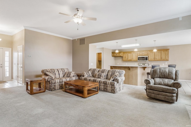 living area with light tile patterned floors, crown molding, visible vents, and light colored carpet