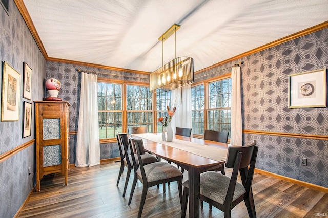 dining room with wood finished floors, a healthy amount of sunlight, crown molding, and wallpapered walls