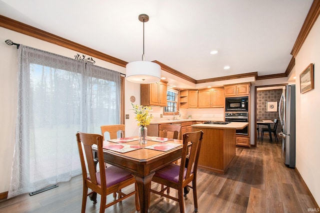 dining area featuring ornamental molding, recessed lighting, visible vents, and dark wood finished floors