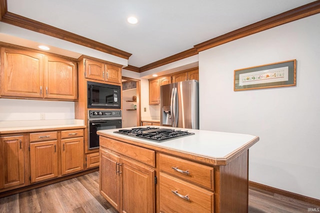 kitchen featuring dark wood-type flooring, light countertops, crown molding, and black appliances