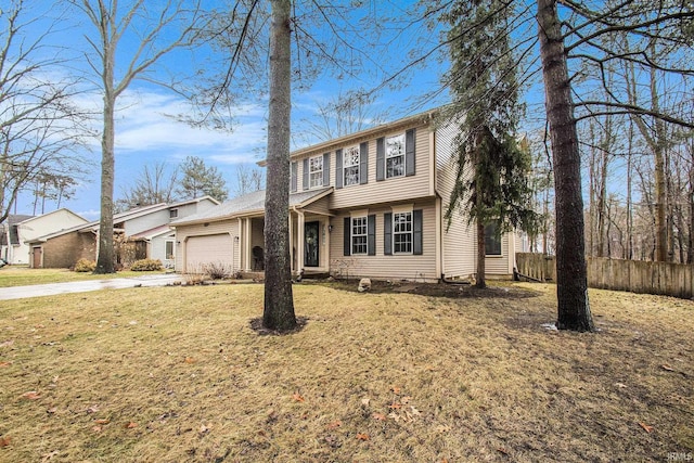 colonial inspired home with a front lawn, concrete driveway, fence, and an attached garage