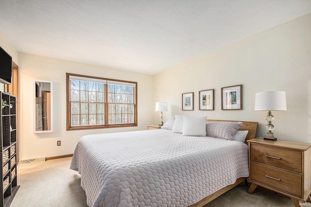 carpeted bedroom featuring visible vents and baseboards