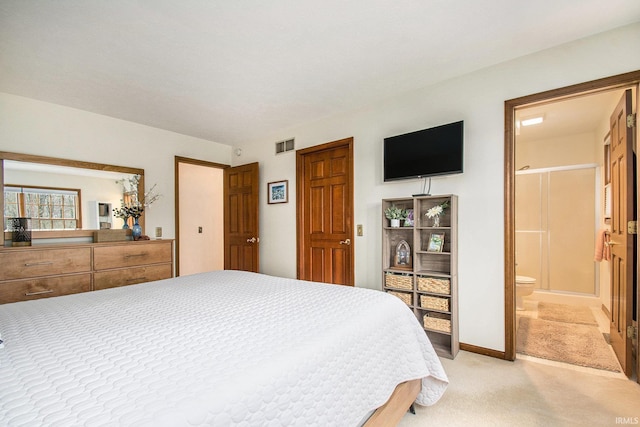 bedroom featuring light carpet, visible vents, and ensuite bathroom