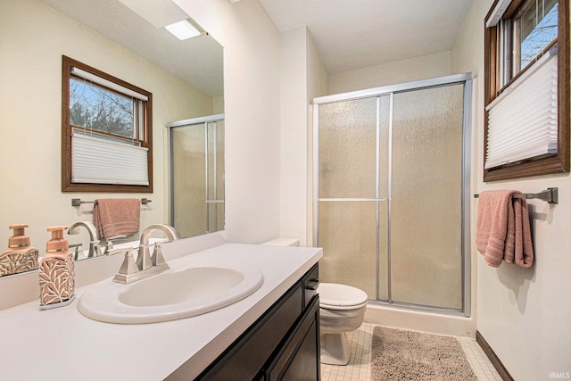 full bathroom with toilet, tile patterned floors, a shower stall, and vanity