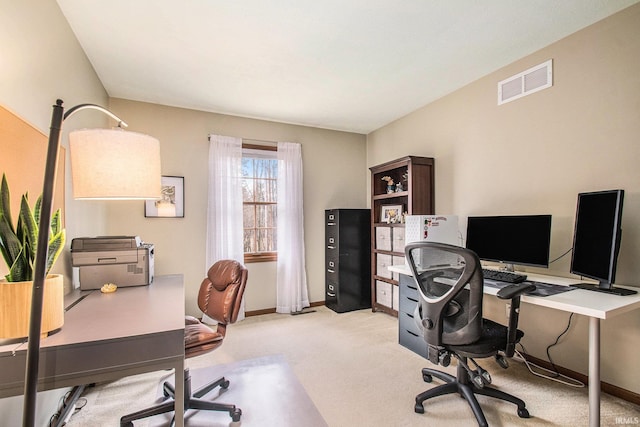 office with baseboards, visible vents, and light colored carpet