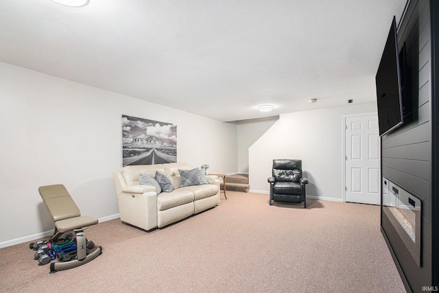 living room with stairs, carpet, and baseboards