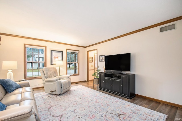 living room featuring baseboards, visible vents, and wood finished floors