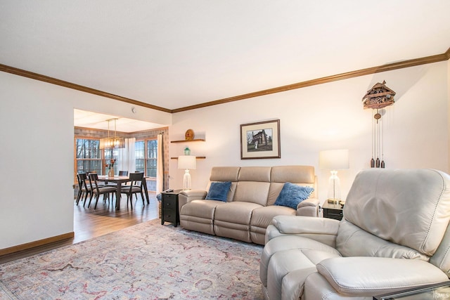 living area featuring baseboards, wood finished floors, and crown molding