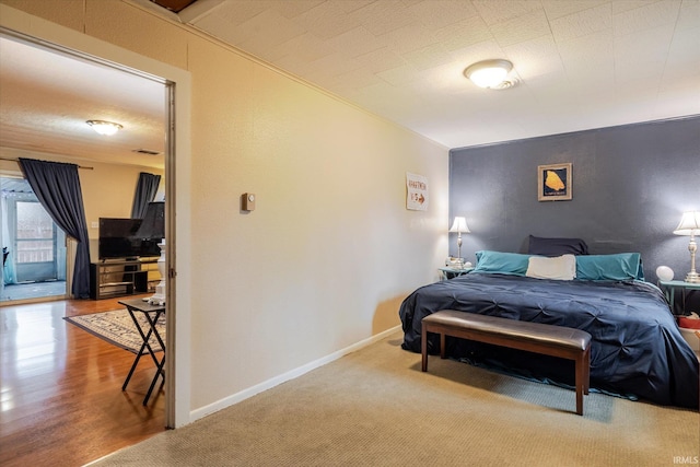 bedroom with baseboards and wood finished floors