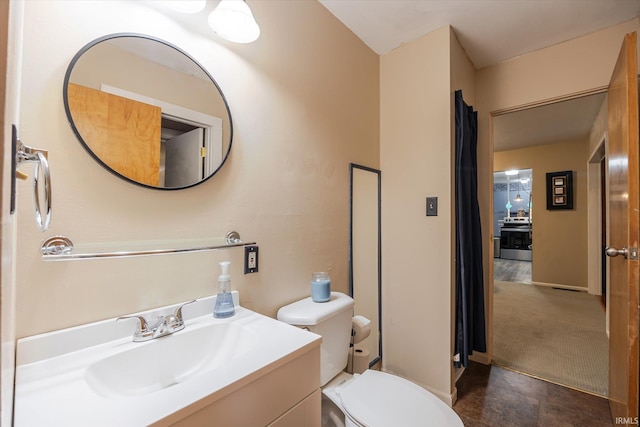 bathroom featuring toilet and vanity