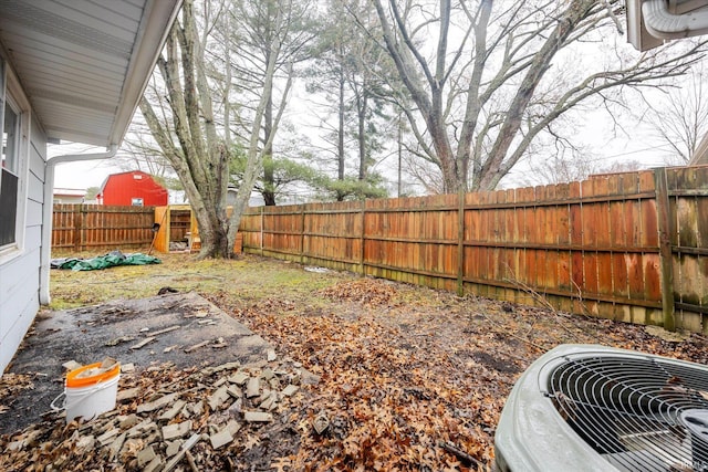 view of yard featuring a fenced backyard and central AC