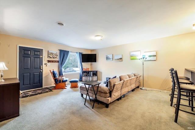 living room featuring baseboards, visible vents, and light colored carpet