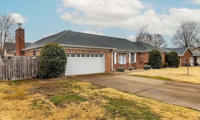 ranch-style home with a shingled roof, concrete driveway, an attached garage, fence, and brick siding