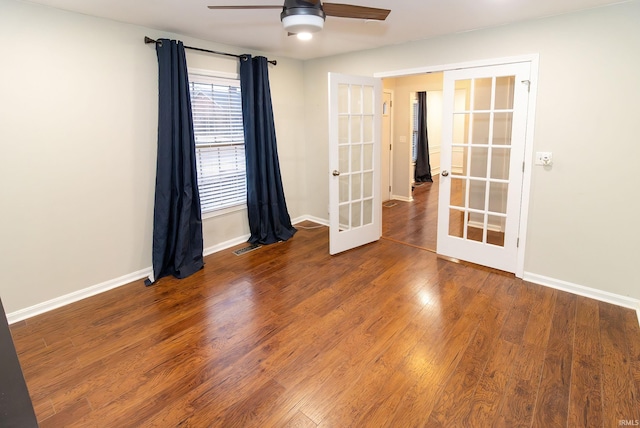 spare room with french doors, ceiling fan, baseboards, and wood finished floors