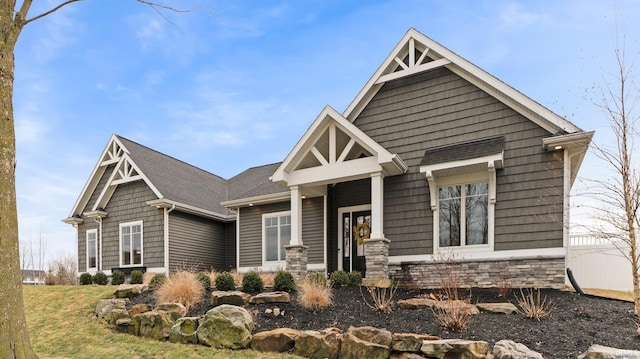 craftsman house featuring stone siding