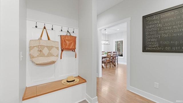 mudroom featuring wood finished floors and baseboards