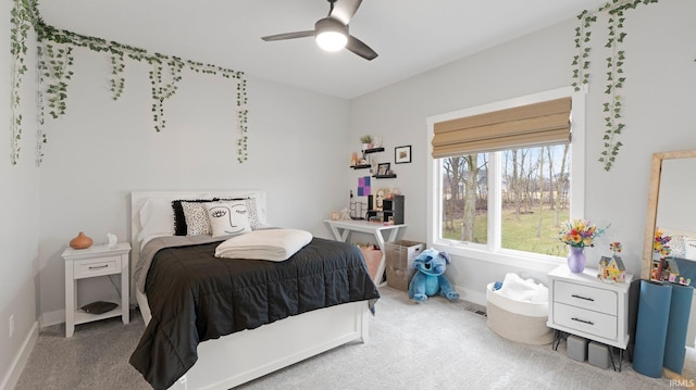 bedroom featuring a ceiling fan, carpet, and baseboards