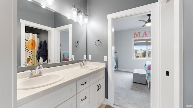 bathroom with double vanity, ensuite bath, and a sink