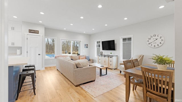 living room with light wood finished floors and recessed lighting