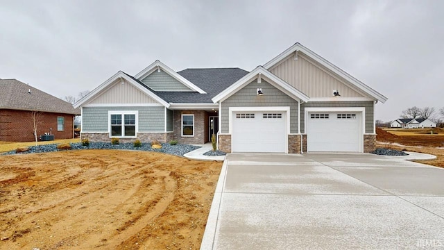 craftsman inspired home featuring a garage, driveway, board and batten siding, and stone siding