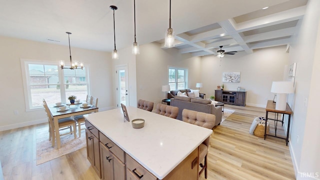 kitchen with light wood-style floors, baseboards, coffered ceiling, and beamed ceiling