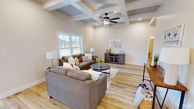 living room with coffered ceiling, beamed ceiling, light wood finished floors, and baseboards