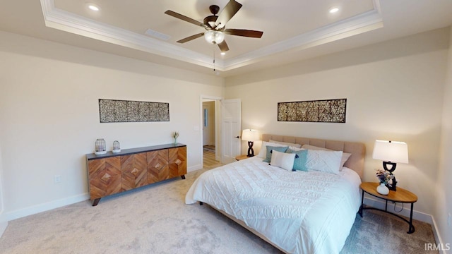 carpeted bedroom featuring recessed lighting, visible vents, baseboards, ornamental molding, and a raised ceiling