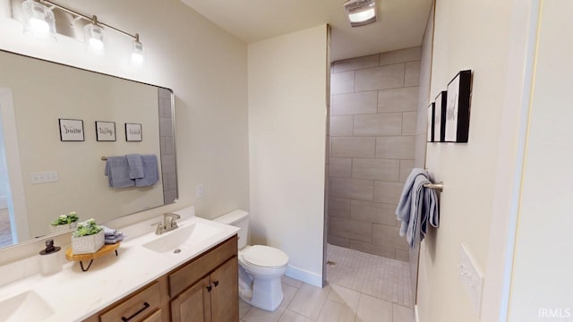 full bath with double vanity, toilet, tile patterned floors, a walk in shower, and a sink