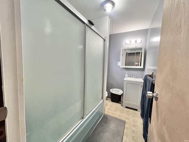 full bath with tile patterned floors, combined bath / shower with glass door, and vanity