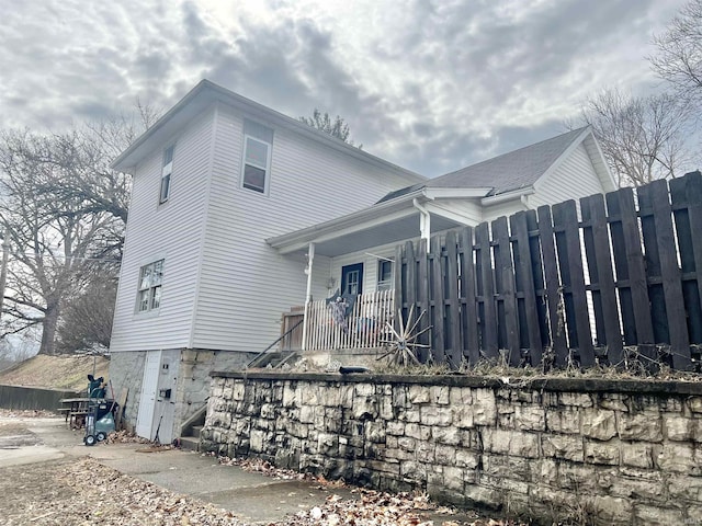 view of side of home with fence