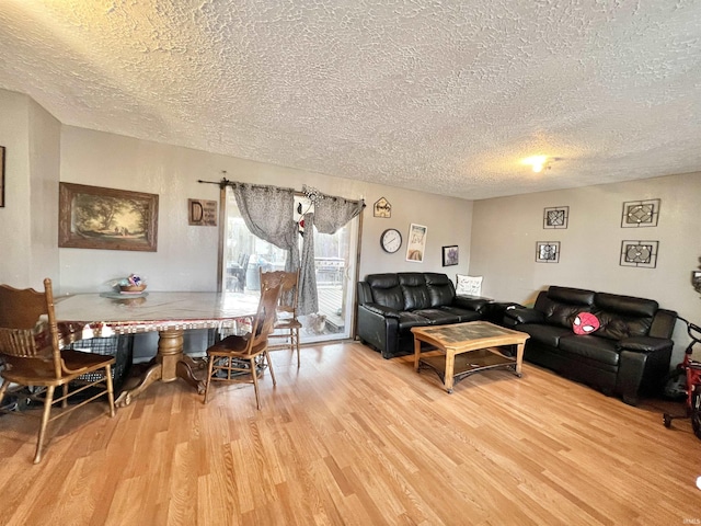 living area with a textured ceiling and wood finished floors