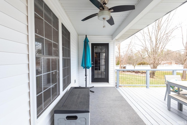 property entrance featuring ceiling fan and fence