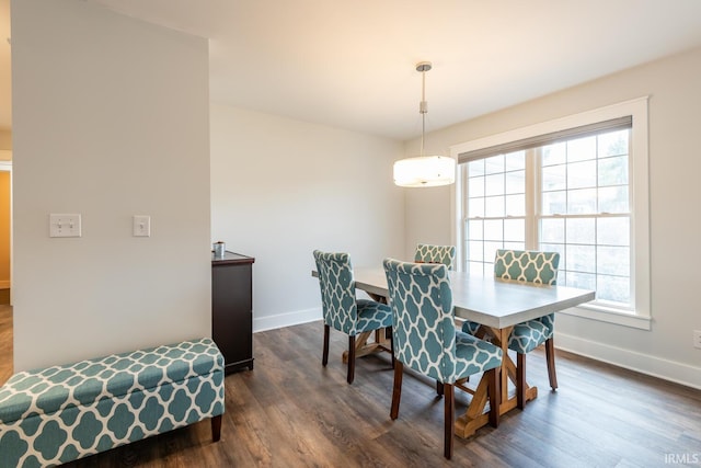 dining room featuring plenty of natural light, baseboards, and dark wood-style flooring