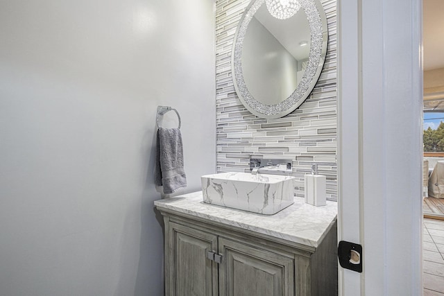 bathroom featuring tasteful backsplash and vanity