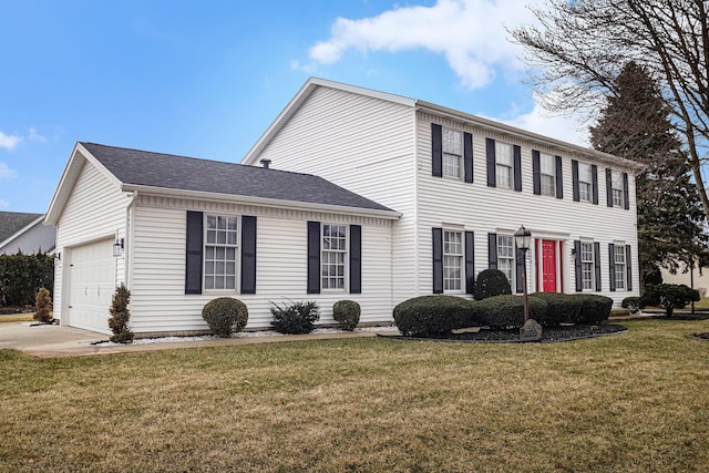 colonial home with a garage, a shingled roof, and a front lawn